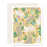 A vibrant Easter card with a sunny yellow background adorned with playful bunnies holding Easter baskets, scattered Easter eggs, carrots, and colorful flowers, creating a delightful scene for Easter celebrations.