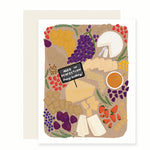 A cheerful birthday card featuring a beautifully illustrated charcuterie board adorned with an array of cheeses and fresh fruits. Nestled among the cheeses is a tiny sign that reads 'aged to perfection. happy birthday.