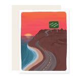 An encouraging card with a breathtaking illustration of a car on a coastal highway. The sunsetting sky paints vibrant hues over the ocean and cliff. A road sign reads 'Good Things Ahead,' symbolizing hope and positivity on the journey.