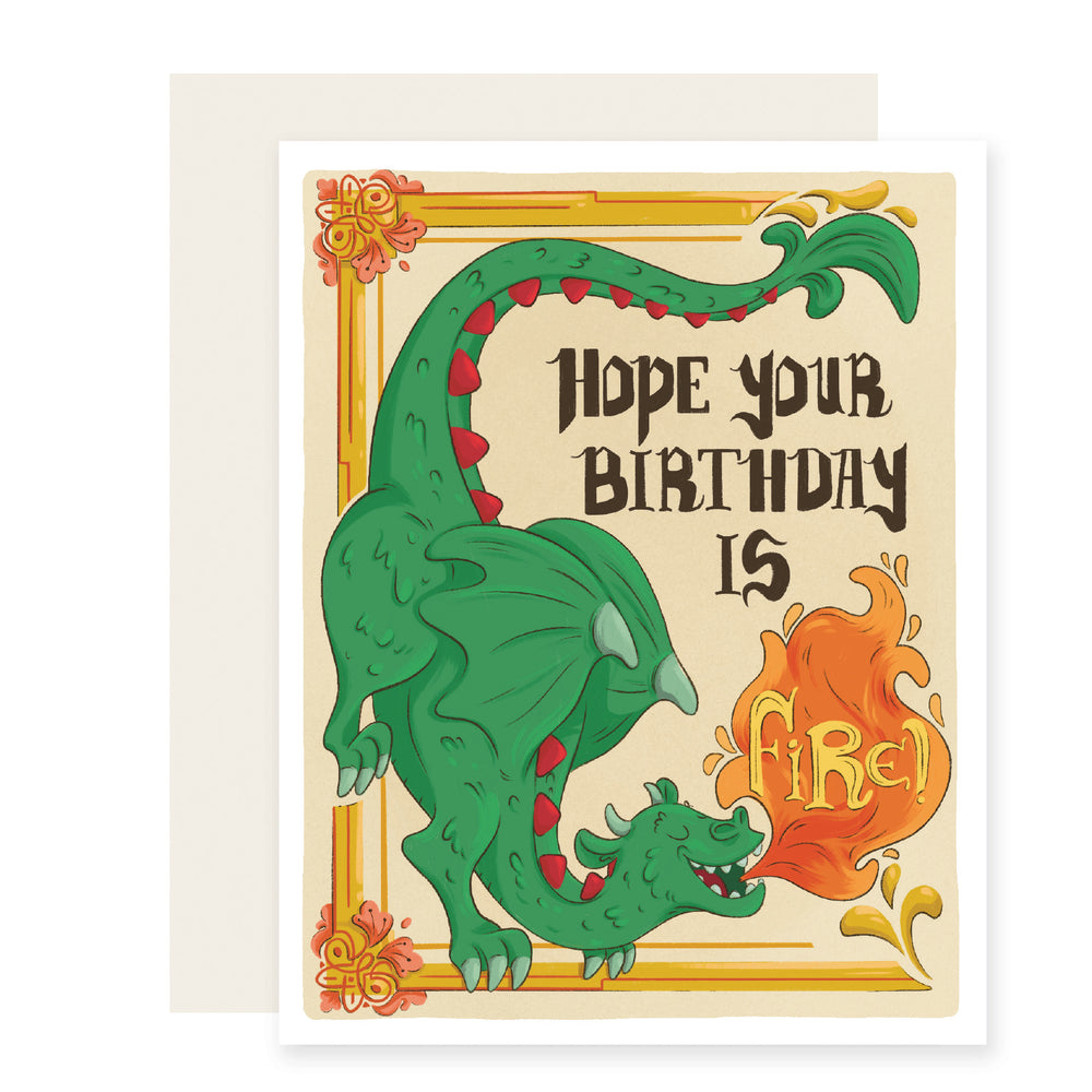 A vibrant birthday card with a colorful green dragon on the front, breathing fire. The card reads, 'Hope your birthday is fire,' adding a touch of excitement and warmth to the celebration.