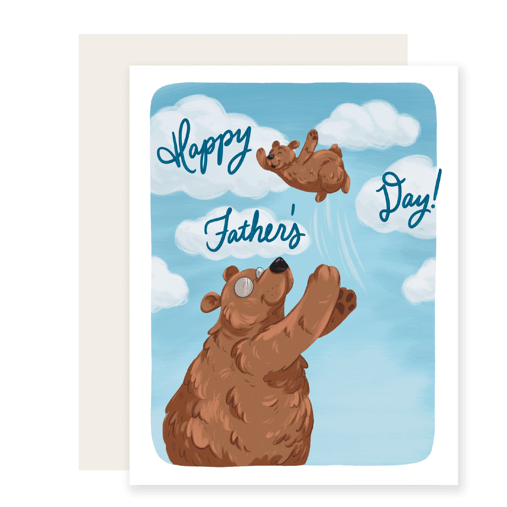 An endearing Father's Day card with a heartwarming illustration of a papa bear tossing a baby bear cub in the air. The illustration is beautifully rendered and evokes feelings of love and joy.