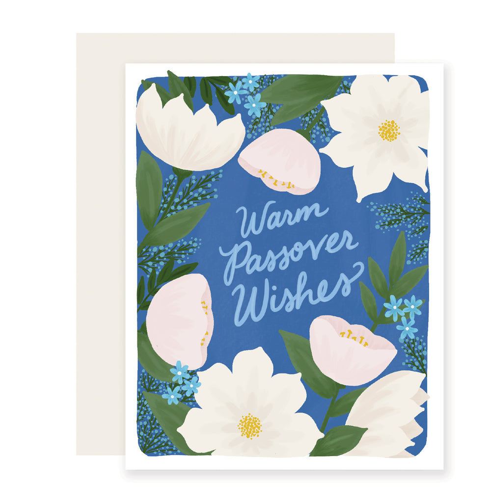 A Passover card with a serene blue background featuring delicate white flowers accented by small blue flowers, accompanied by the text "Warm Passover Wishes."
