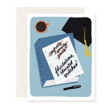 A graduation card with vibrant illustrations of a thesaurus with a piece of paper that reads 'Felicitations, educated britches.' Alongside, there's a delightful graduation cap and a cup of coffee, exuding warmth and celebration.