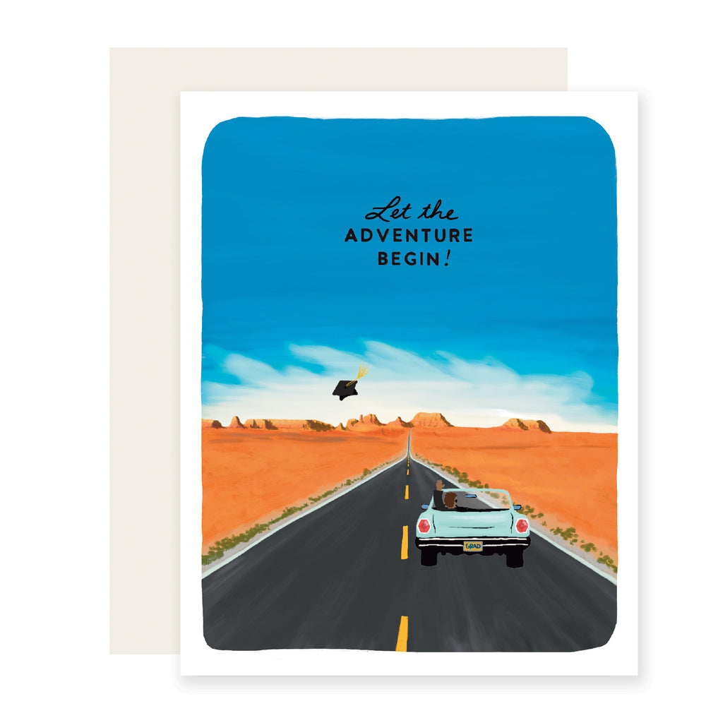 A vibrant graduation card featuring a scenic view of a blue sky, open road, and classic convertible. A graduation cap is tossed in the air. The card reads 'Let the adventure begin.