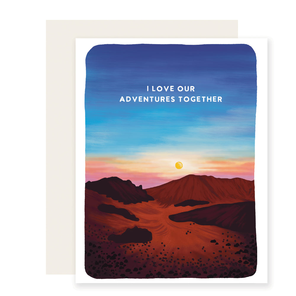 A beautifully illustrated love card depicting rolling sandstone hills under a breathtaking sunset sky. The sky transitions from bright blue to warm hues of yellow orange  and pink. Celebrate your adventure partner with a stunning scenic backdrop. 