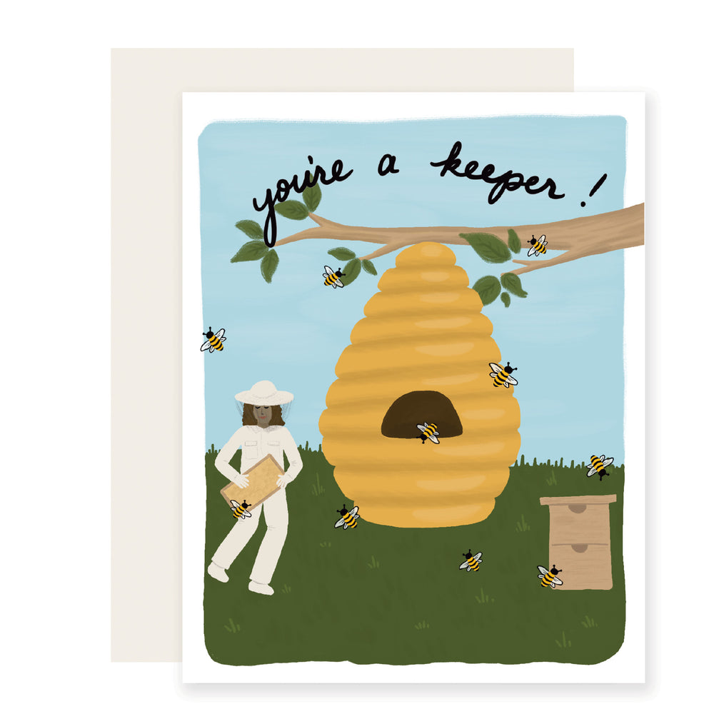 A love card with a colorful illustration of an adorable beekeeper and beehive on the front. The card reads 'You're a Keeper,' radiating warmth and affection.