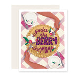 A Mother's Day card featuring a delightful berry pie with two hands sharing the pie. The background showcases a lightly checkered tablecloth. The message 'You're the berry best mom' is written on the pie.