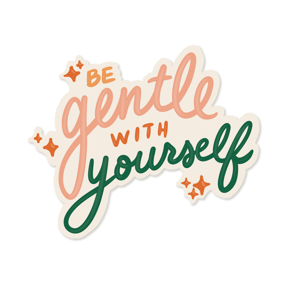 A sticker with the hand-lettered inscription 'Be gentle with yourself' in peach and green. Small orange stars sprinkle the design, and the soft, cloud-like background adds to the whimsical, self-care theme. 