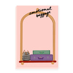 A light pink notepad with a whimsical illustration of a bellhop framing the notepad. The bellhop carries colorful luggage at the bottom, while at the top of the notepad, it humorously reads Emotional Baggage, sure to bring a smile to your face.