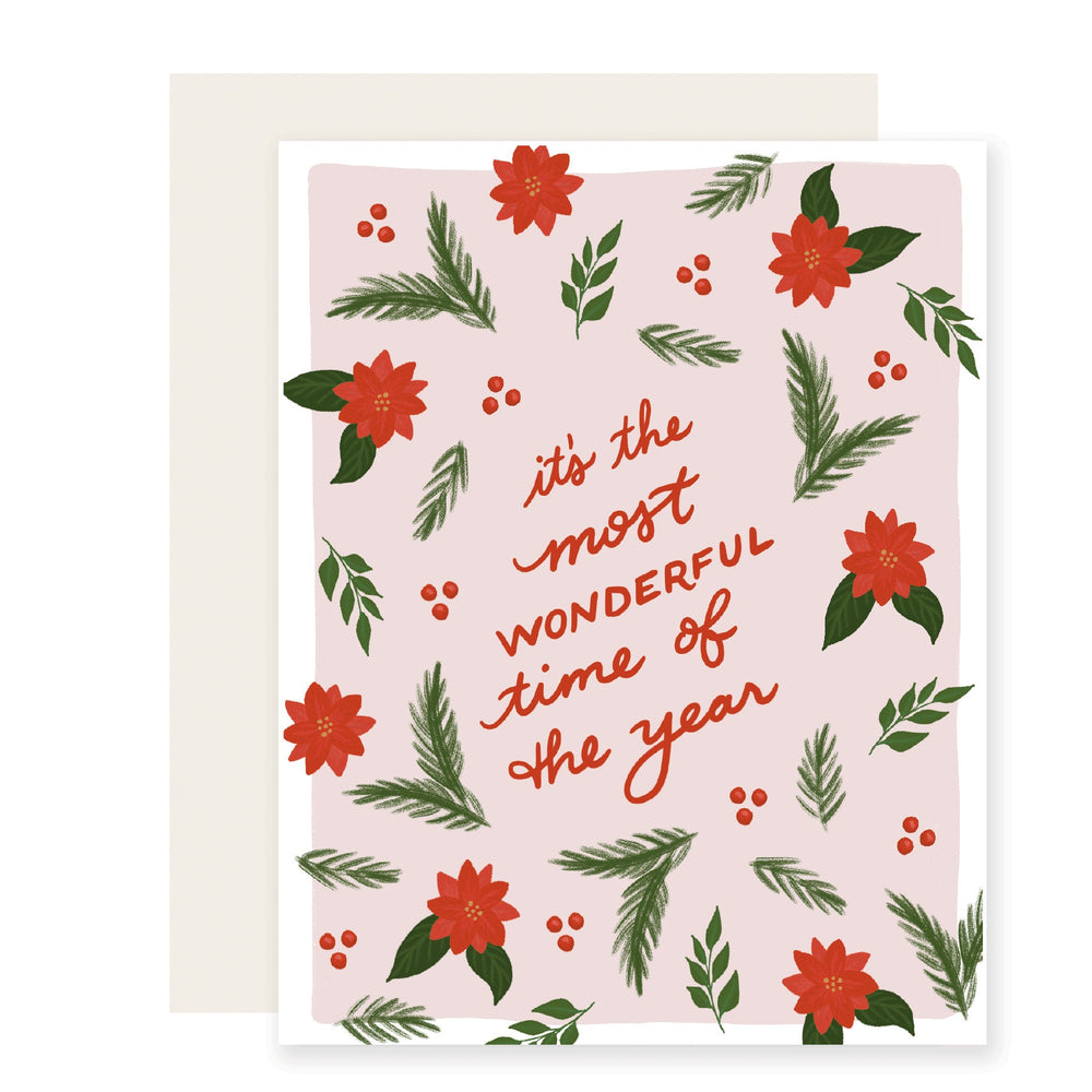 A beautifully illustrated holiday card featuring festive greenery such as Christmas tree branches and poinsettias. The card reads 'It's the most wonderful time of the year!' invoking a warm and joyful holiday spirit.