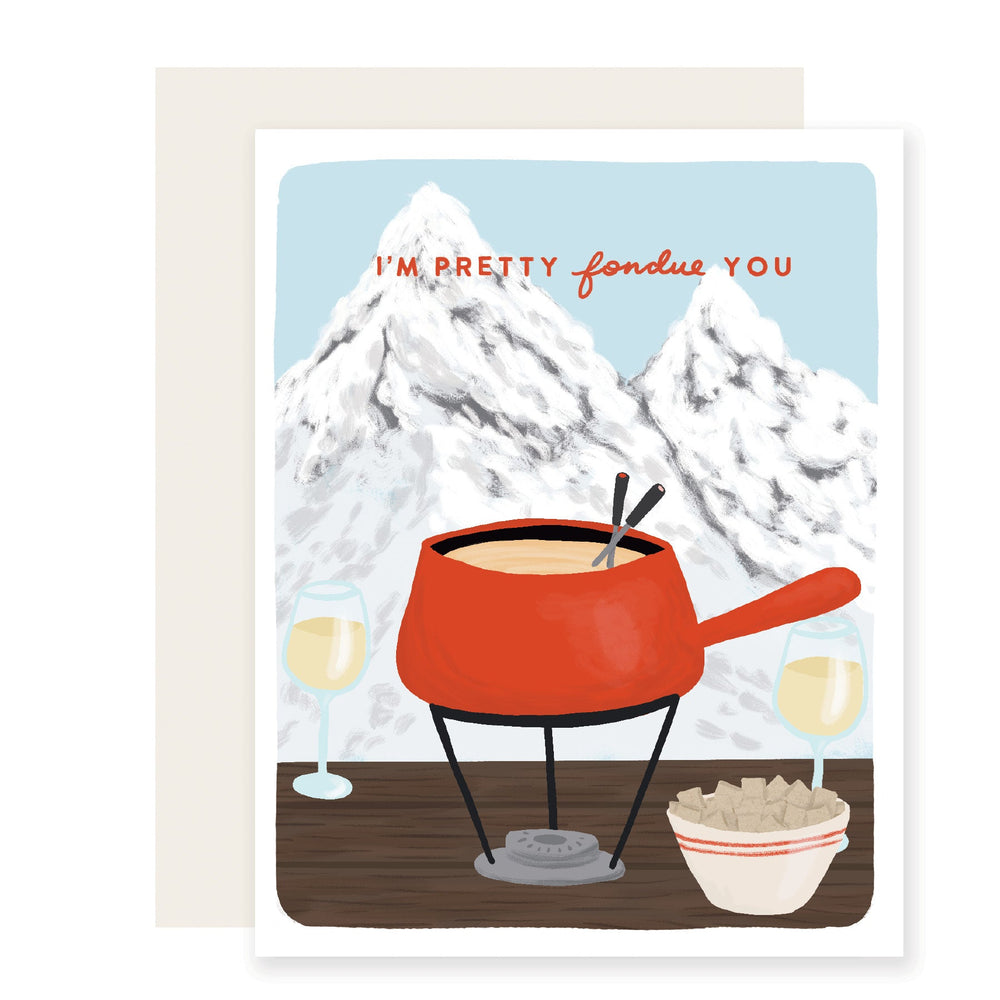 A charming love card with a punny message, ''m pretty fondu of you, set against an adorable illustration featuring Swiss mountains in the background, a fondue pot, and two glasses of wine, creating a warm and affectionate scene. 
