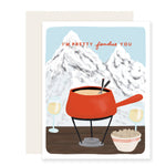 A charming love card with a punny message, ''m pretty fondu of you, set against an adorable illustration featuring Swiss mountains in the background, a fondue pot, and two glasses of wine, creating a warm and affectionate scene. 