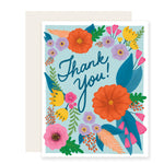 A vibrant and bold thank you card adorned with beautifully illustrated flowers, featuring colorful, hand-painted blooms. The card simply reads 'Thank You,' exuding gratitude in a cheerful and artistic manner.