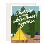 Cozy card adorned with a yellow tent, evergreen trees, and a campsite, echoing 'Cheers to many adventures together.' Ideal for your cherished adventure buddy or celebrating the joy of an outdoorsy couple. 🌲💛