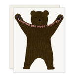 An adorably illustrated card features a warm, cheery bear holding a simple banner that reads, 'sending big hugs your way.'