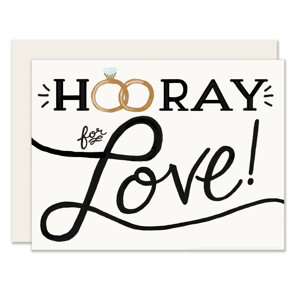 Simplicity meets sentimentality in this wedding card featuring the message 'Hurray for love.' The card's design includes wedding rings cleverly replacing the 'o's in 'Hooray,' symbolizing the couple's union and celebration of their love.