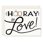 Simplicity meets sentimentality in this wedding card featuring the message 'Hurray for love.' The card's design includes wedding rings cleverly replacing the 'o's in 'Hooray,' symbolizing the couple's union and celebration of their love.